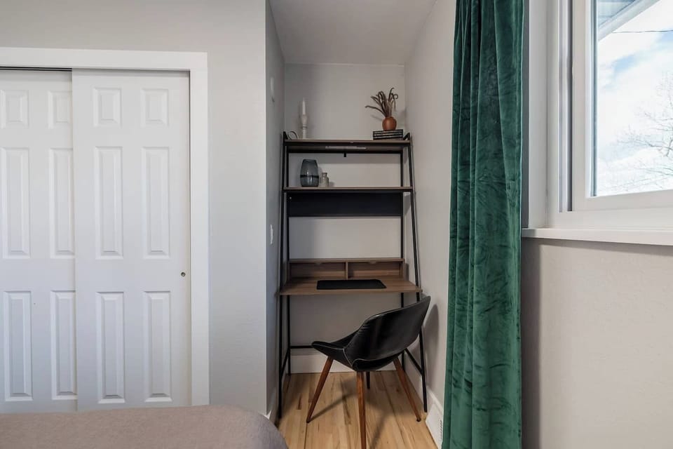 - Stay productive with a dedicated desk and comfy chair nestled into a quiet corner
- Natural light from the window makes this a perfect spot for work or journaling
- Shelves with charming decor and essentials keep your workspace organized and inspir