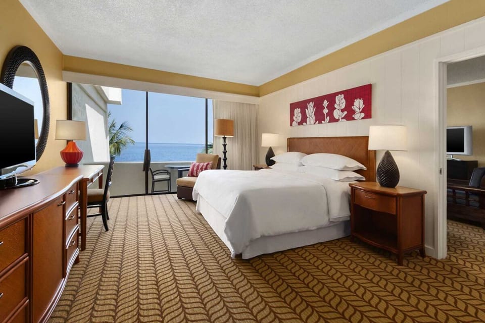 Stretch out in a serene bedroom with airy coastal outlook.