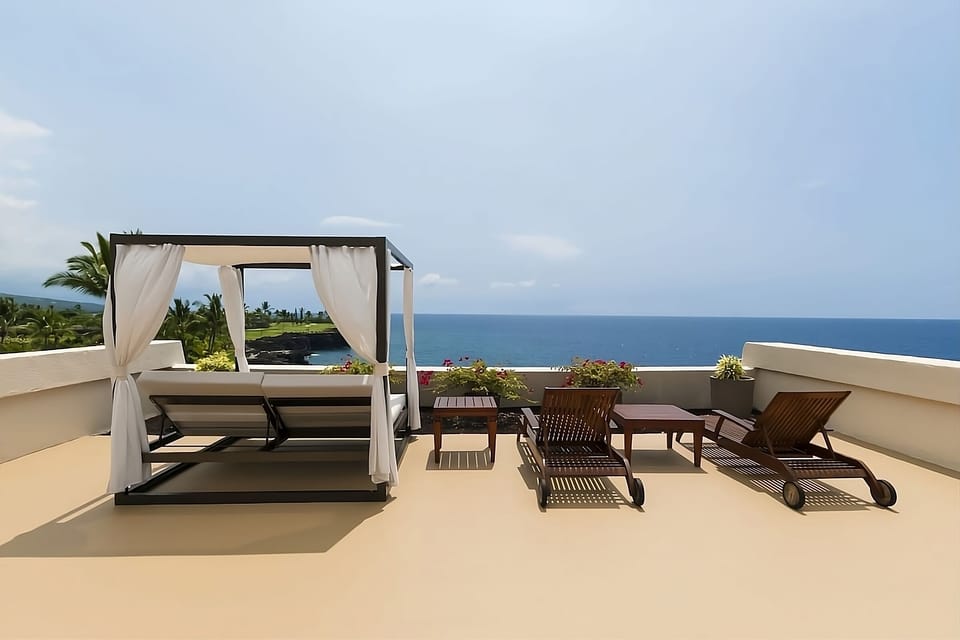Unwind on a breezy rooftop daybed with endless ocean views.