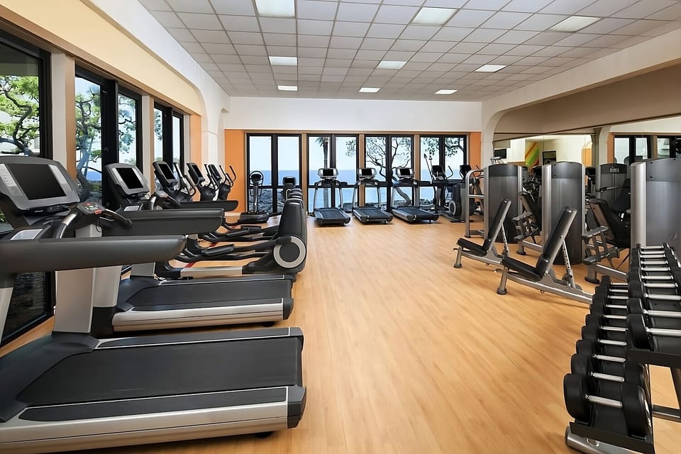 Keep your routine strong in a bright, fully equipped fitness room.