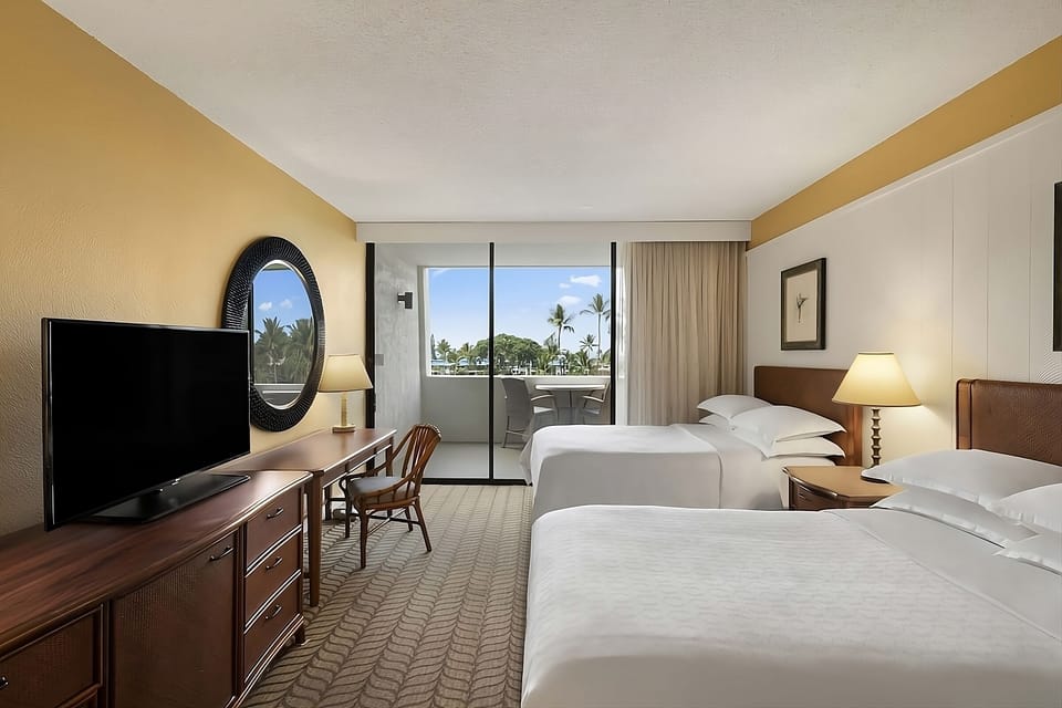 Settle in with crisp linens, TV, and balcony sunshine.