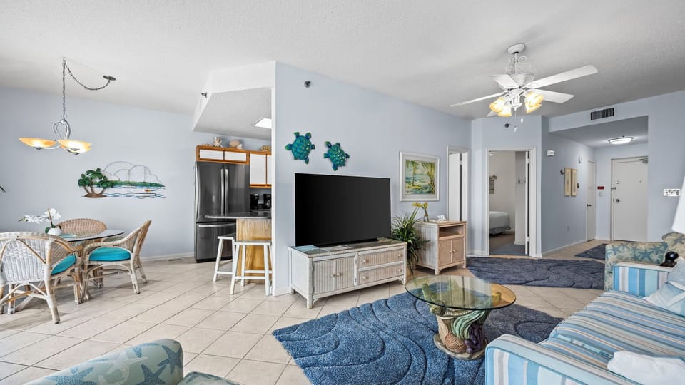 Gather around the cozy living area to enjoy family movie nights, surrounded by vibrant coastal decor