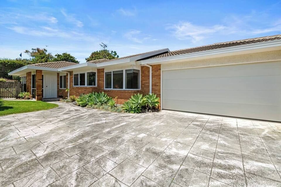 Front of house with double garage and additional parking.