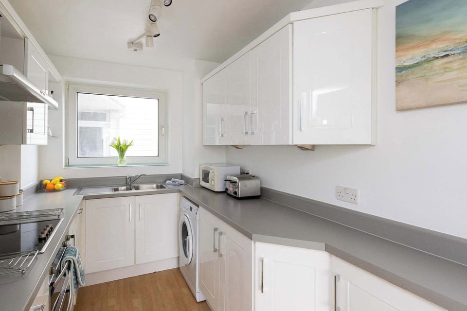 Bright and practical kitchen with generous counter space and modern appliances for easy, stress-free holiday cooking.