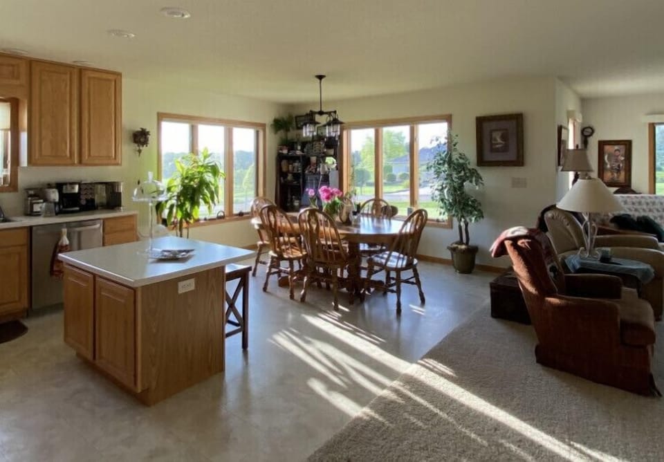 Open kitchen/dining area looking out the windows at the golf course.