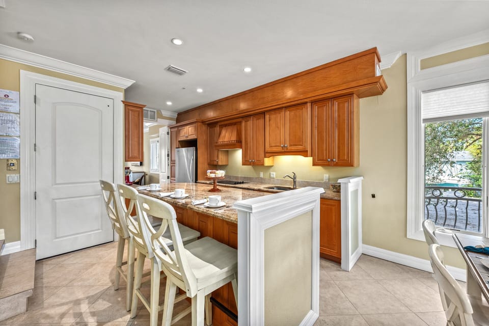 Everything you need, right where you want it—this fully equipped kitchen features sleek countertops, stainless appliances and breakfast bar seating for casual mornings.