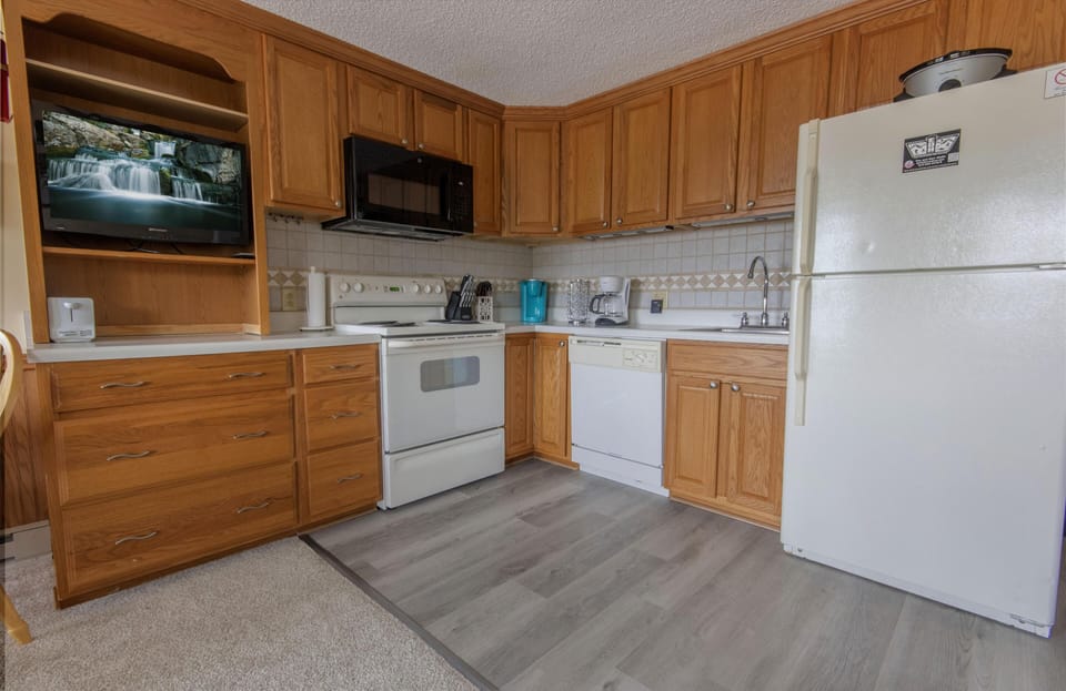 The comfortable kitchen is fully equipped so you can cook meals inside the property.