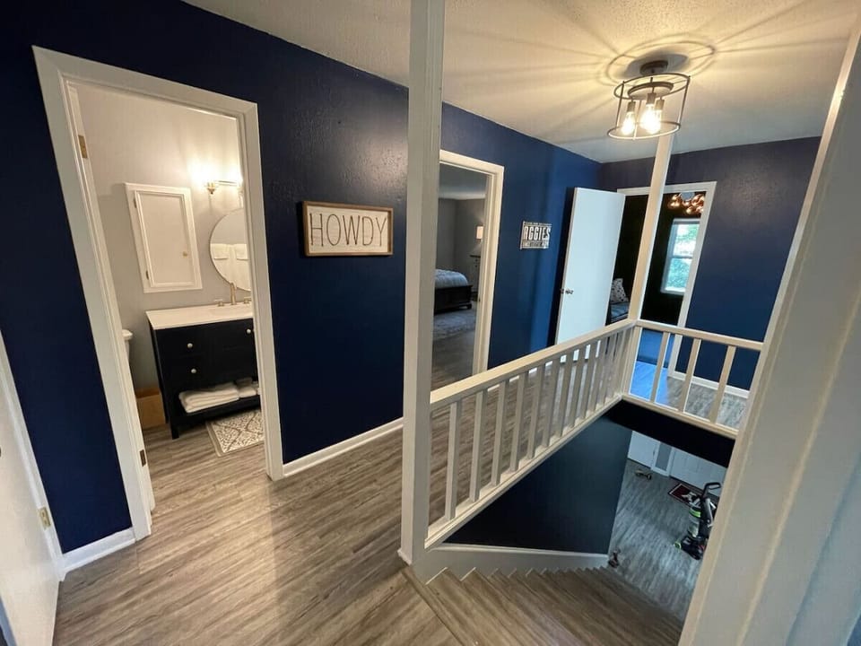 A wide shot of the stairwell & upstairs hallway