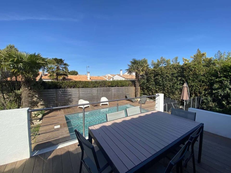View of the pool from the terrace with outdoor lounge
