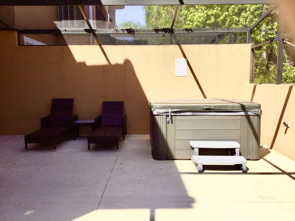 Private, covered lanai with lounge area and hot tub