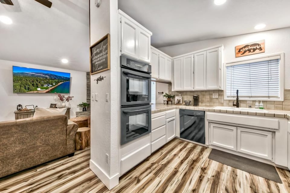 The kitchen is complete with double ovens, a dishwasher, built-in microwave, and French door fridge/freezer.