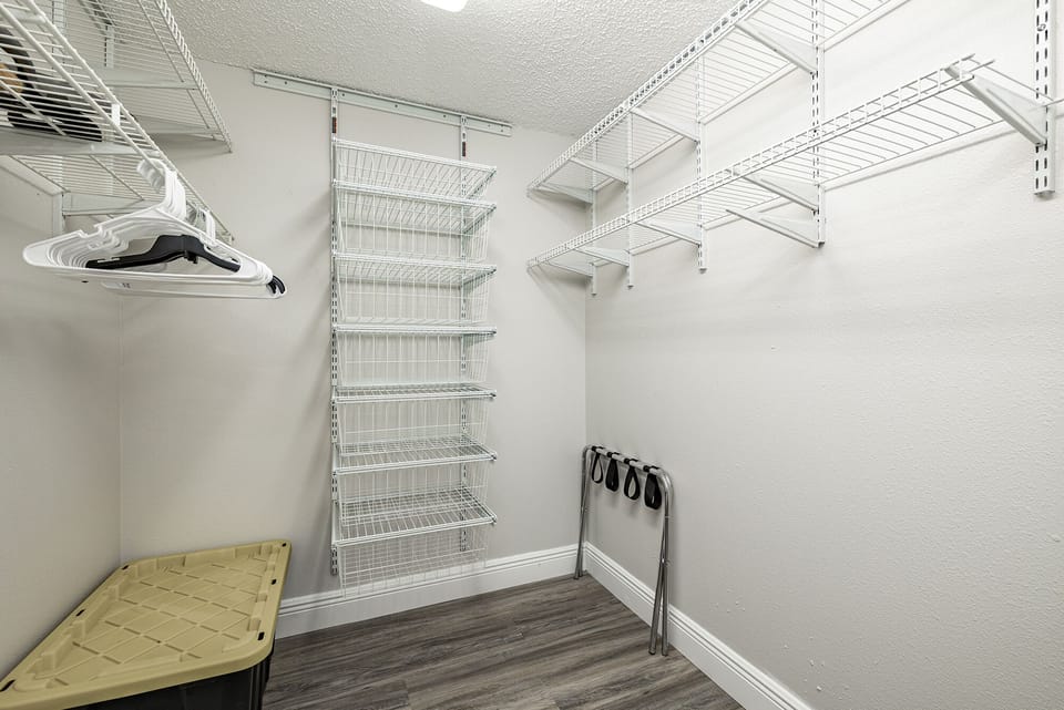 Double queen bed walk through closet with tub of children's sand toys