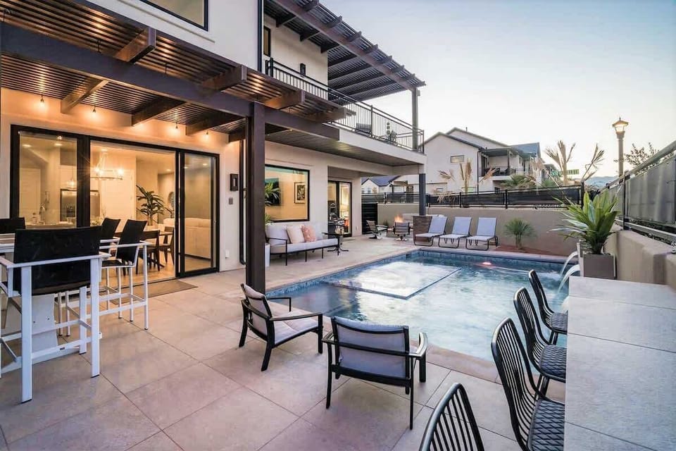 Poolside dining with table and additional bar
