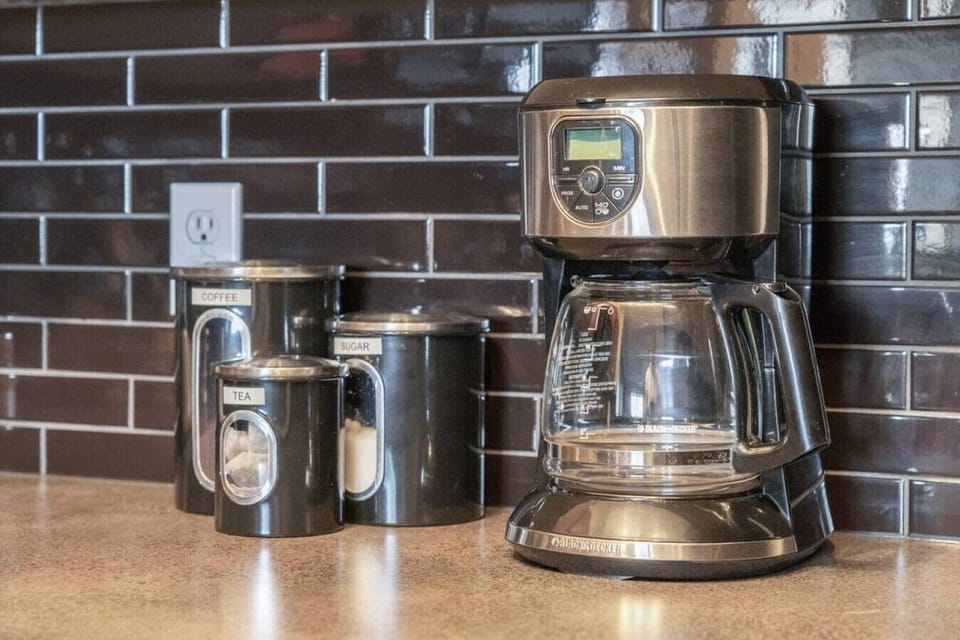 Full kitchen with a drip coffee machine, ground coffee, tea, sugar and basic condiments (ketchup, mustard and relish.)
