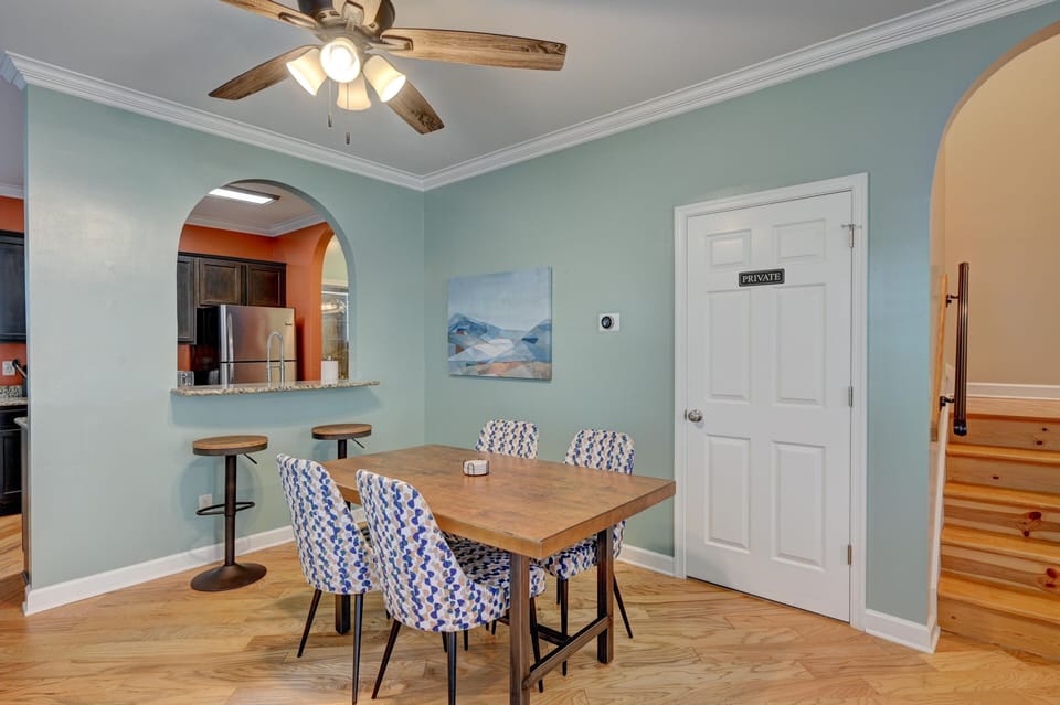 Dining area with barstools overlooking kitchen.