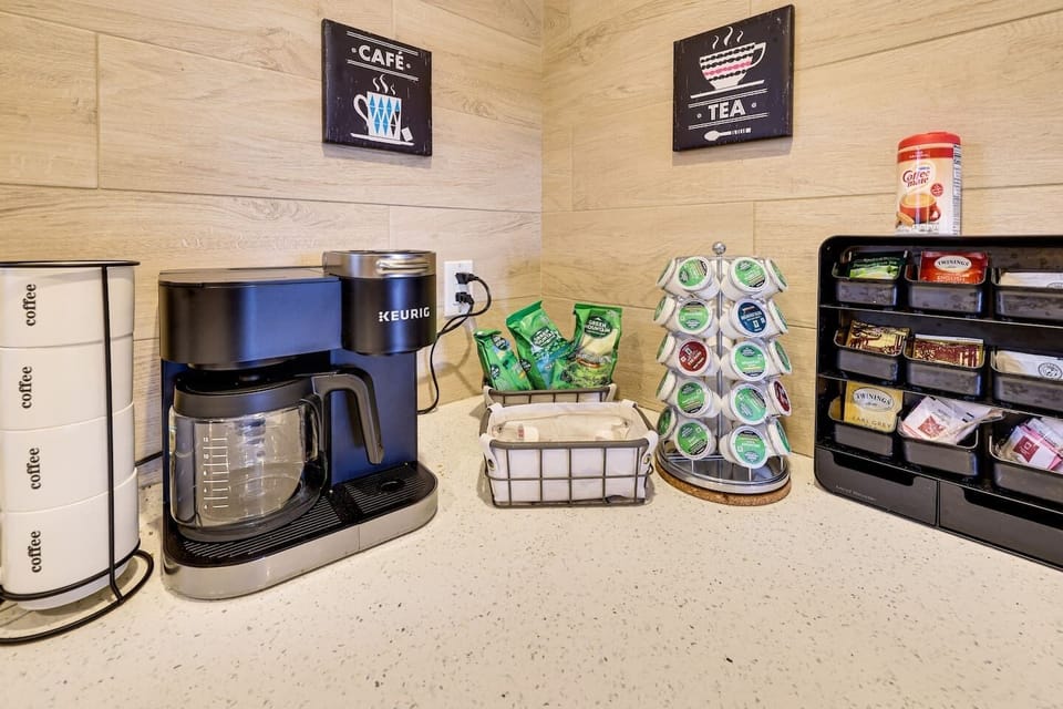 Complimentary Coffee and Tea's, Keurig coffee machine with k-cups and drip machine option. Ceramic mugs, creamers, sugar and sweetener and an assortment of teas and coffee flavors.