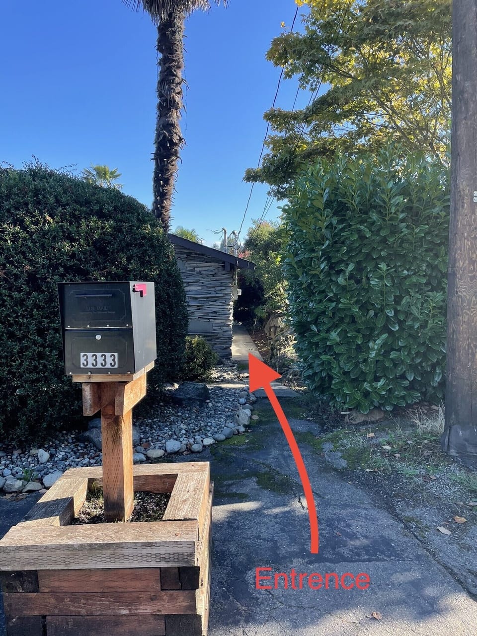 The sidewalk on the right side of the house to the Airbnb.