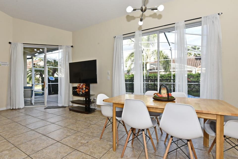 Comfortable dining room with pool view.