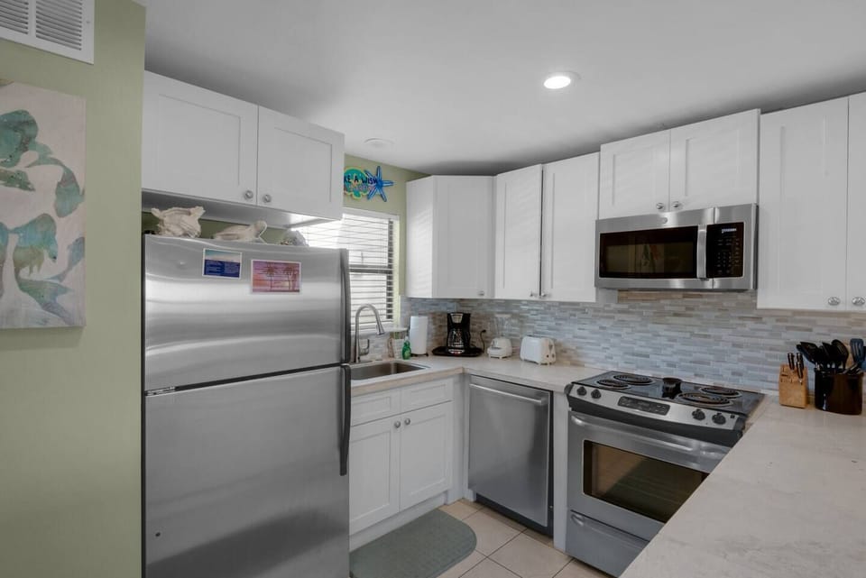 Recently remodeled kitchen has stainless appliances and new countertops - fully stocked to prepare meals in your home away from home