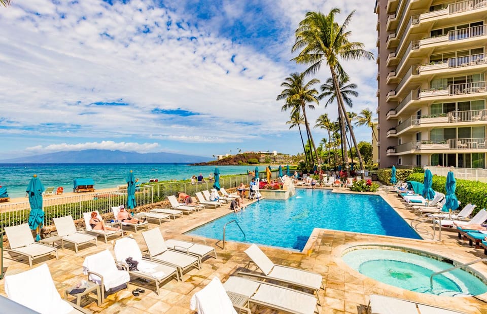 Lounge by the sparkling beachfront pool
                