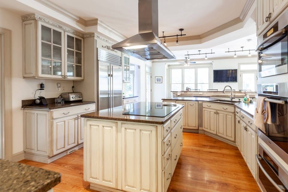 In addition to the large commercial grade stainless steel fridge, there are multiple high-end appliances.