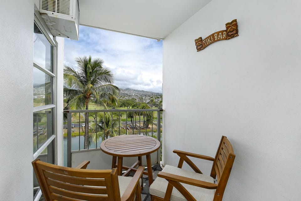 Lanai - Small private lanai with table and seating for 2 overlooking the Ala Wai Canal and Golf Course