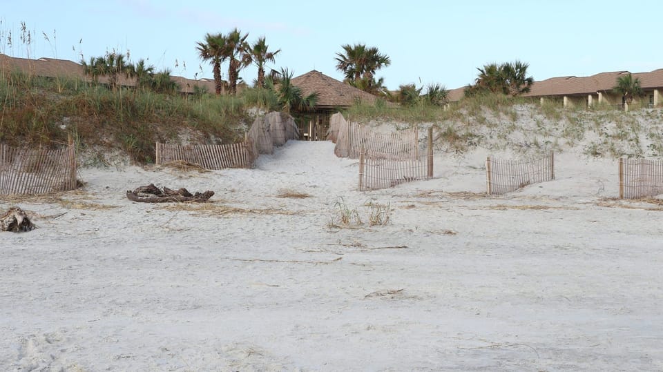 Private boardwalk leading to wide uncrowded beach. 