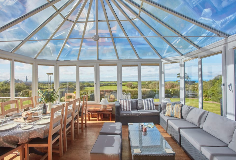 Seawynds, Trelights. Ground floor: Spacious living area in the conservatory with dining area for ten guests. Views overlooking the garden and distant sea views