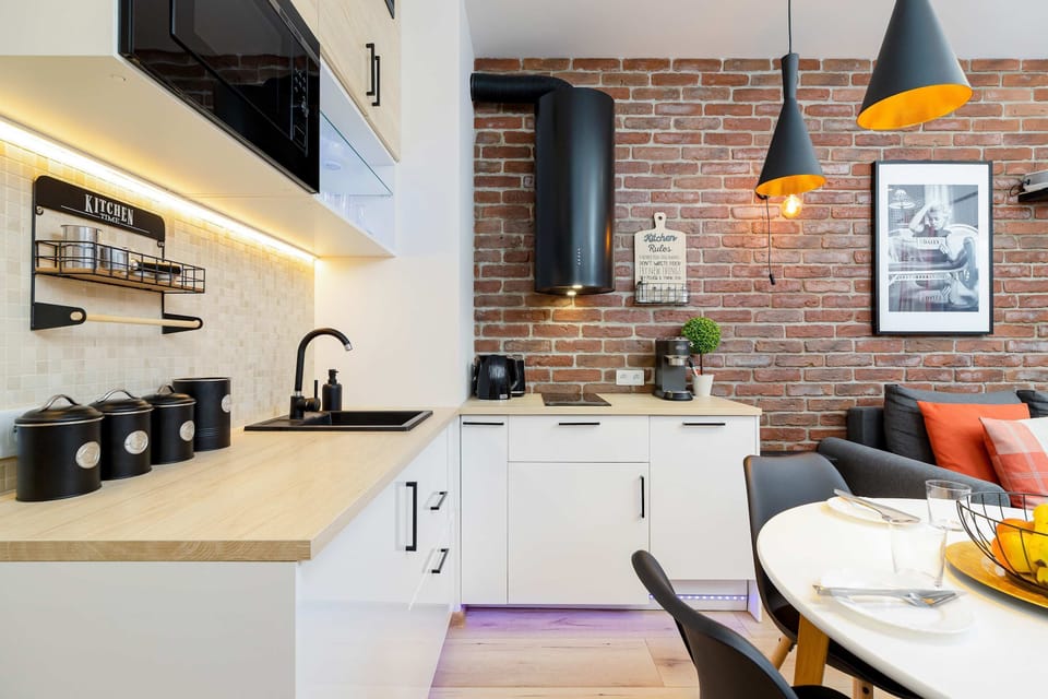 Kitchenette and dining table with tableware.