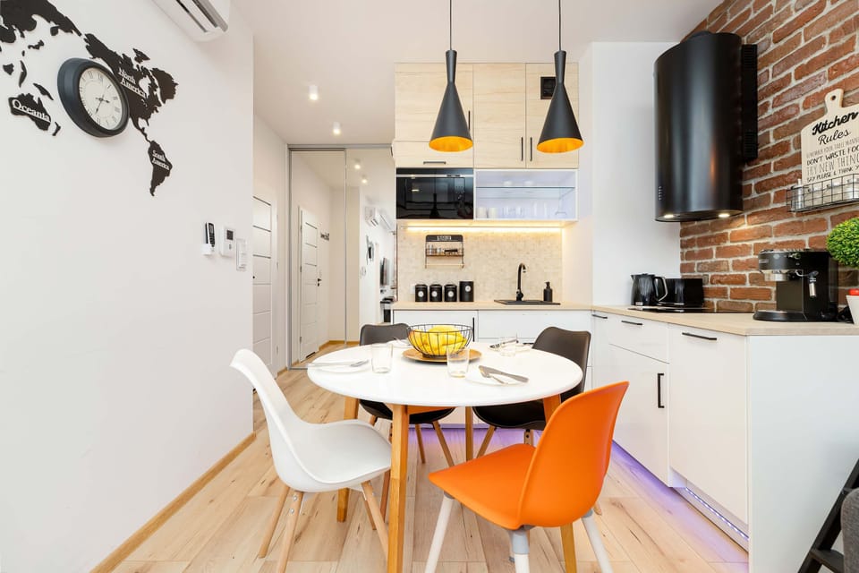 Kitchenette and dining table with tableware.