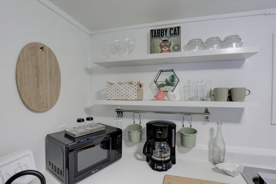 Coffee, heat, and serve—kitchen essentials for a hassle-free stay.