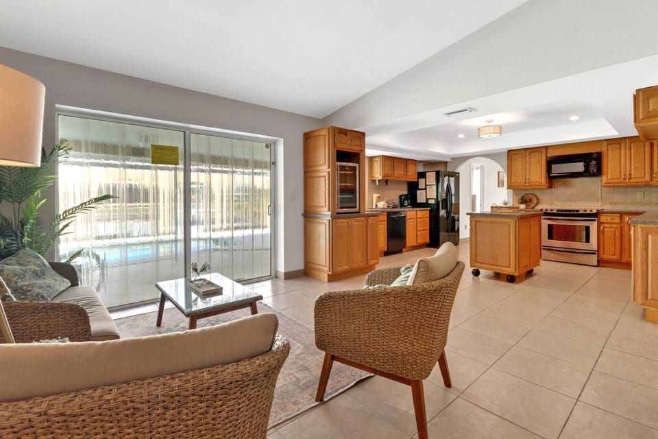 An additional seating space combined with the kitchen is a great gathering area with pool access.