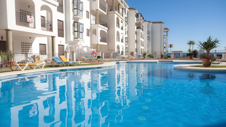 One of four large pools with sunbathing terrace and garden surrounds.