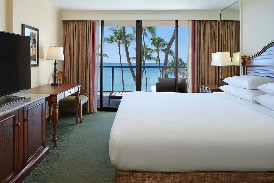 Lounge in bed with postcard-worthy palms and turquoise water.