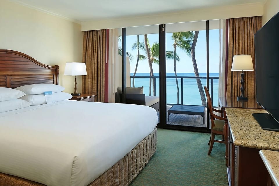 Wake up to palm-framed ocean views from your bed.