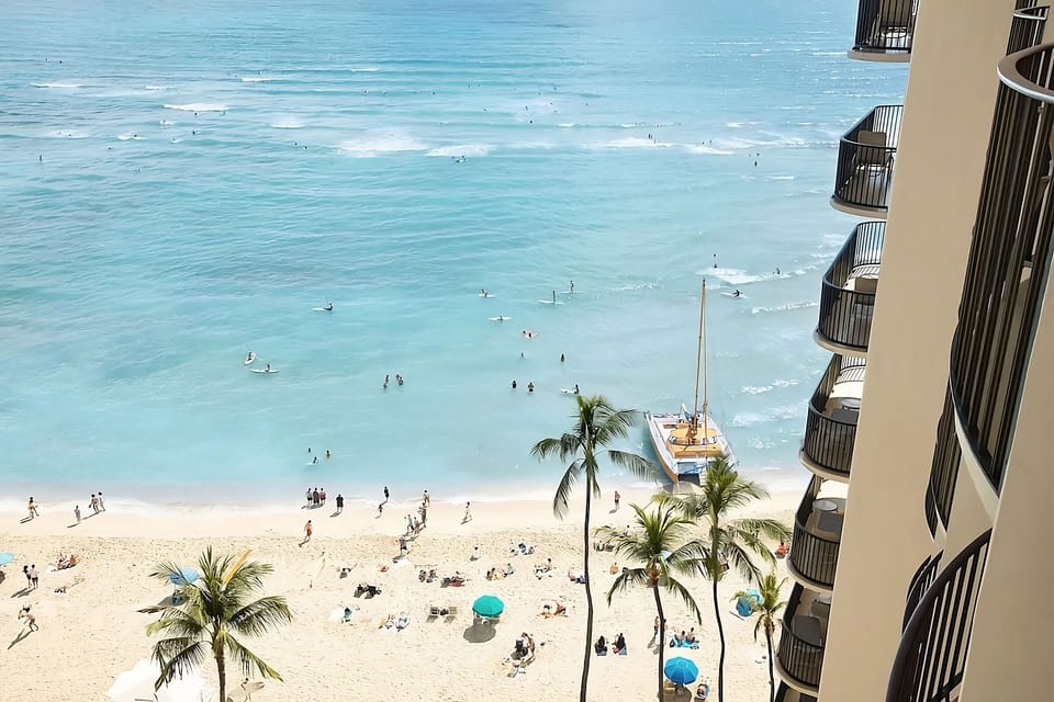 Watch surfers glide through turquoise waters just steps away.