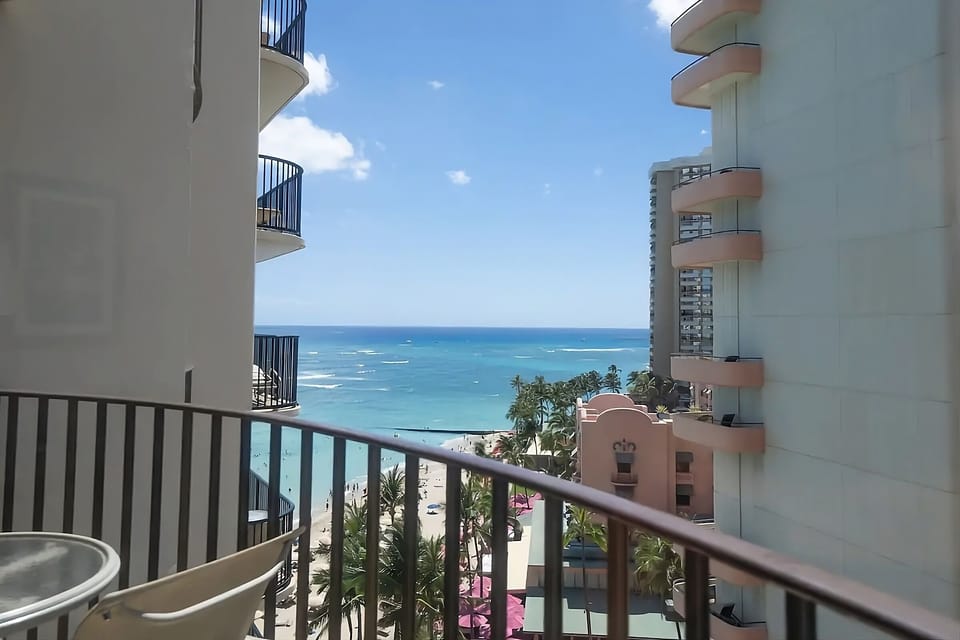 Wake up to sparkling water views framed by neighboring towers.
