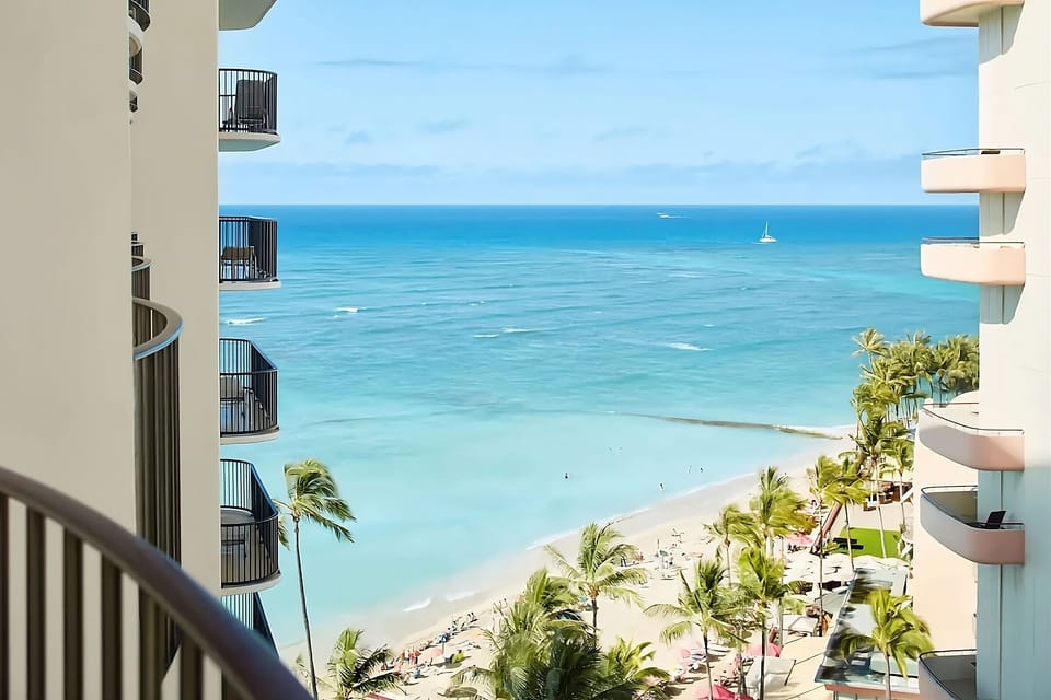 Peek out to brilliant blue waters between resort balconies.