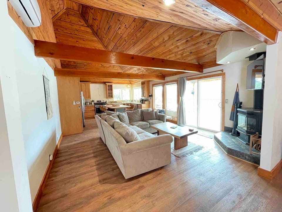 Sectional couch surrounds gas fireplace.
