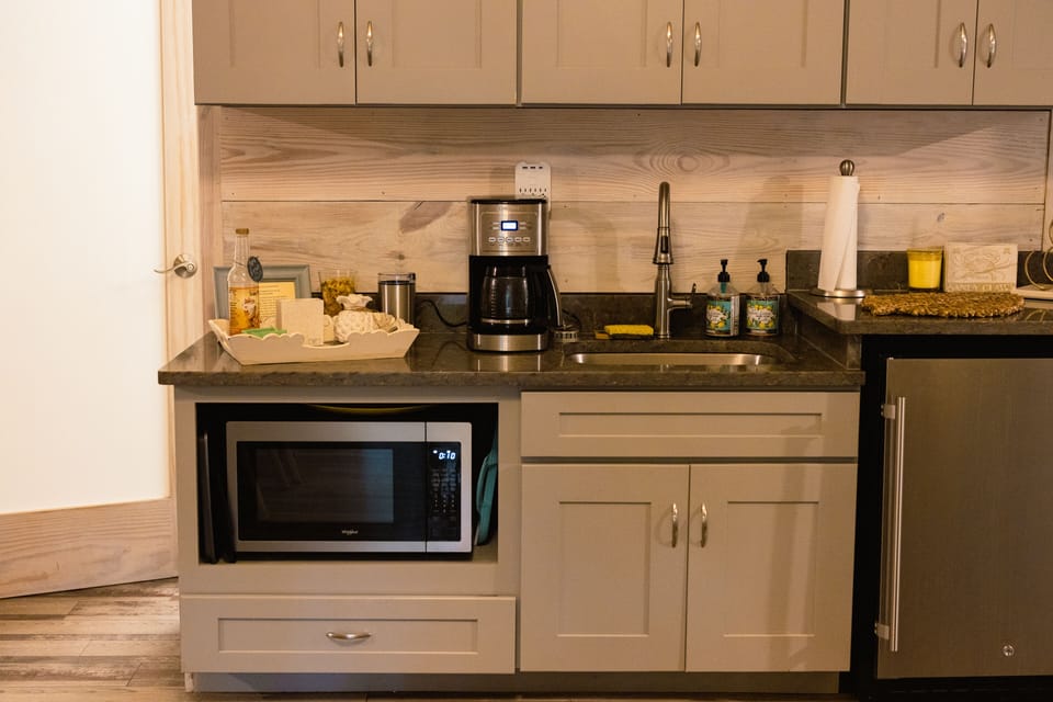 The Clearwater Kitchenette features a microwave, small fridge & dishes.  
