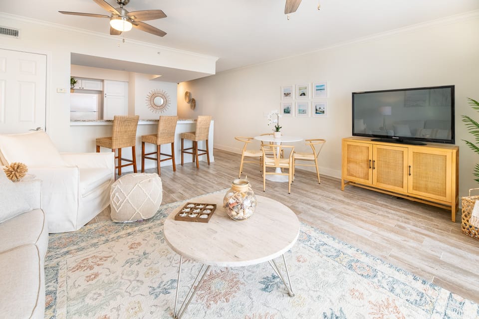 Spacious living room with 50" smart TV, queen sleeper sofa and large arm chair.