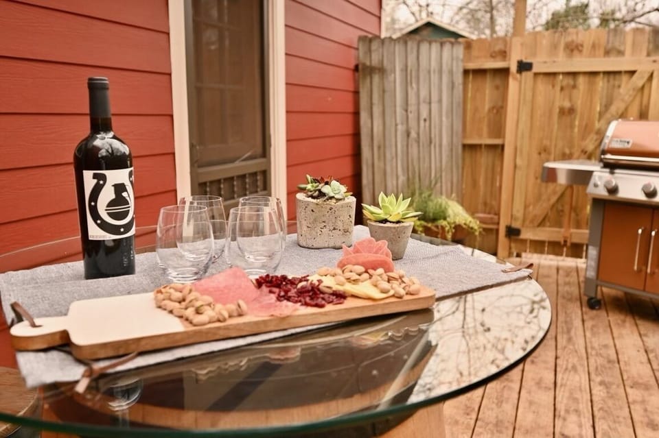 Outdoor entertaining space with a French  barrel cocktail table and bar stools.