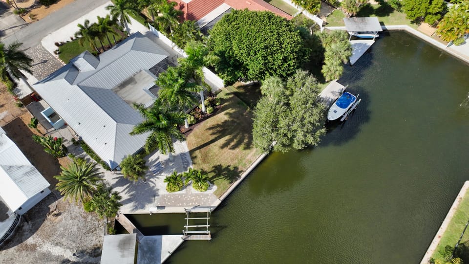 Drone view with home and the backyard canal access.
