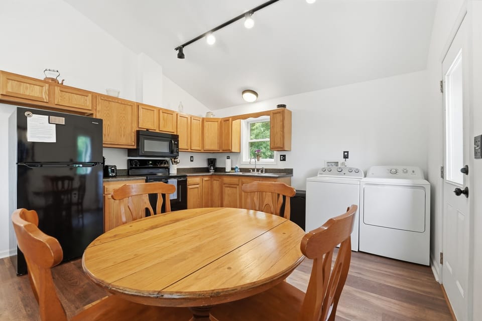 Kitchen, oven, refrigerator, stovetop, dining table, microwave, washer/dryer