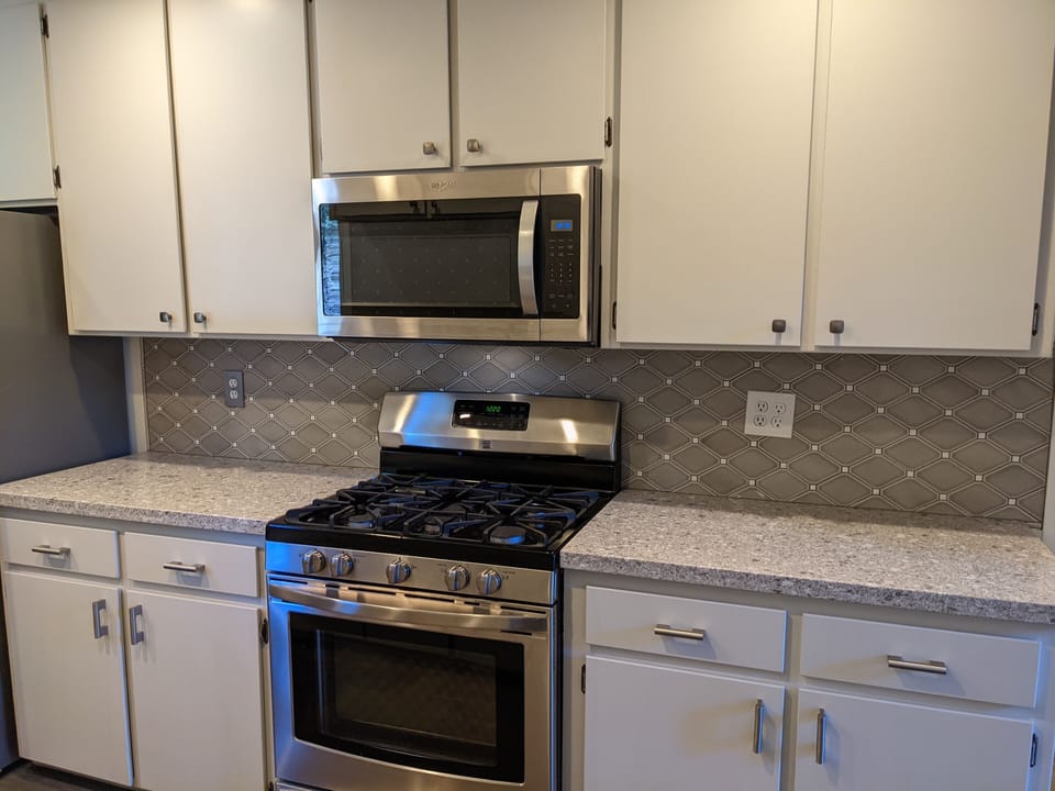 Gas stove and full-sized microwave. 