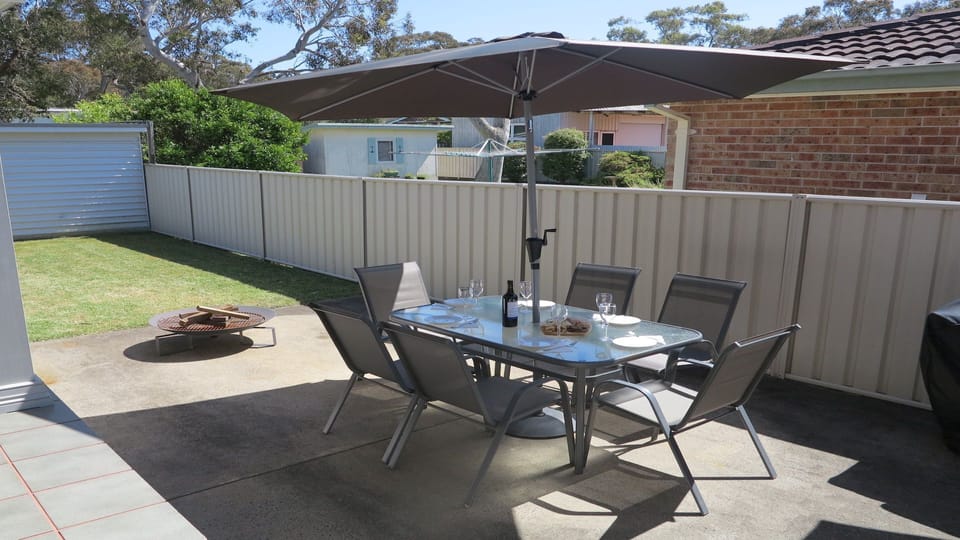 Alka Beach House | Outdoor dining | Umbrella | Enclosed yard