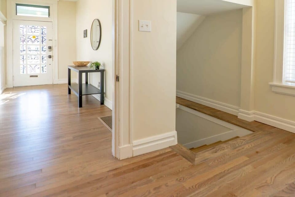 Stairwell to the finished basement with two bedrooms, full bath, and laundry room