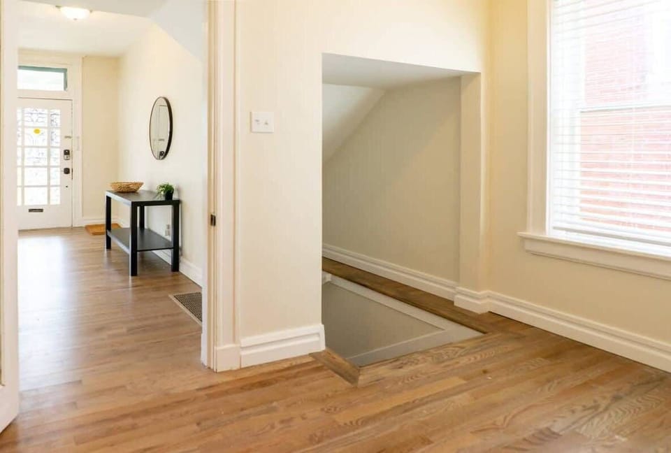 Stairwell to the finished basement with two bedrooms, full bath, and laundry room - Lower Unit