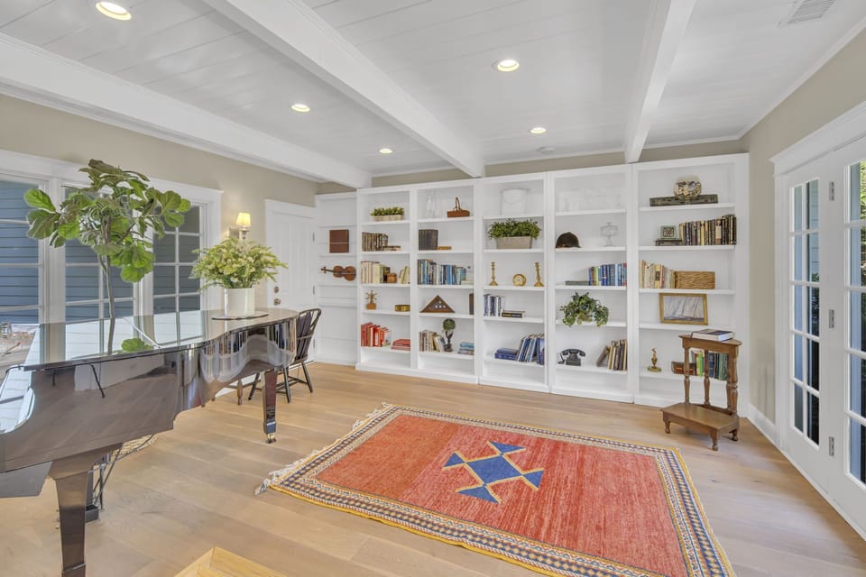 Quiet room with a piano and access to the back courtyard