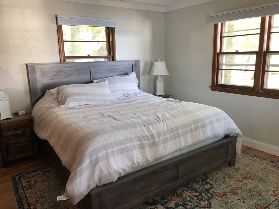 Bedroom with king and wireless chargers.